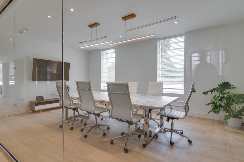 The conference room seen from the corridor, with a screen on the wall
