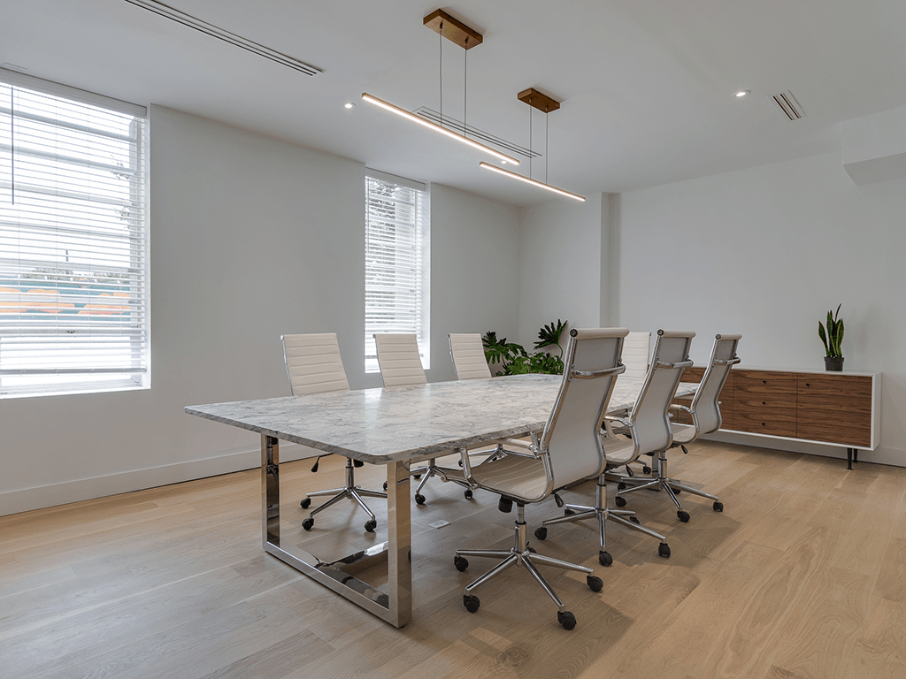 The shared conference room with a marble table and seven chairs