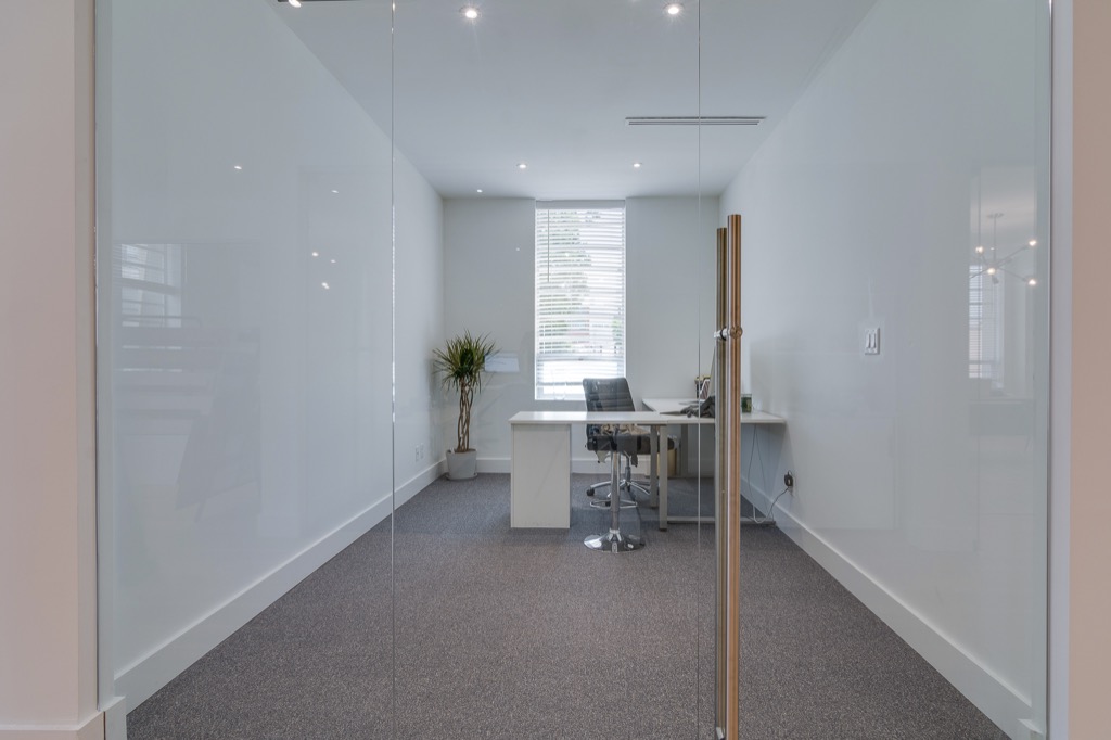 A glass-fronted office with a street window